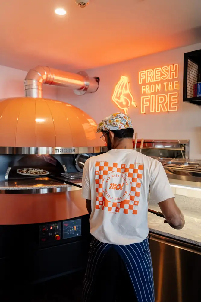 Pizza chef at the woodfired oven